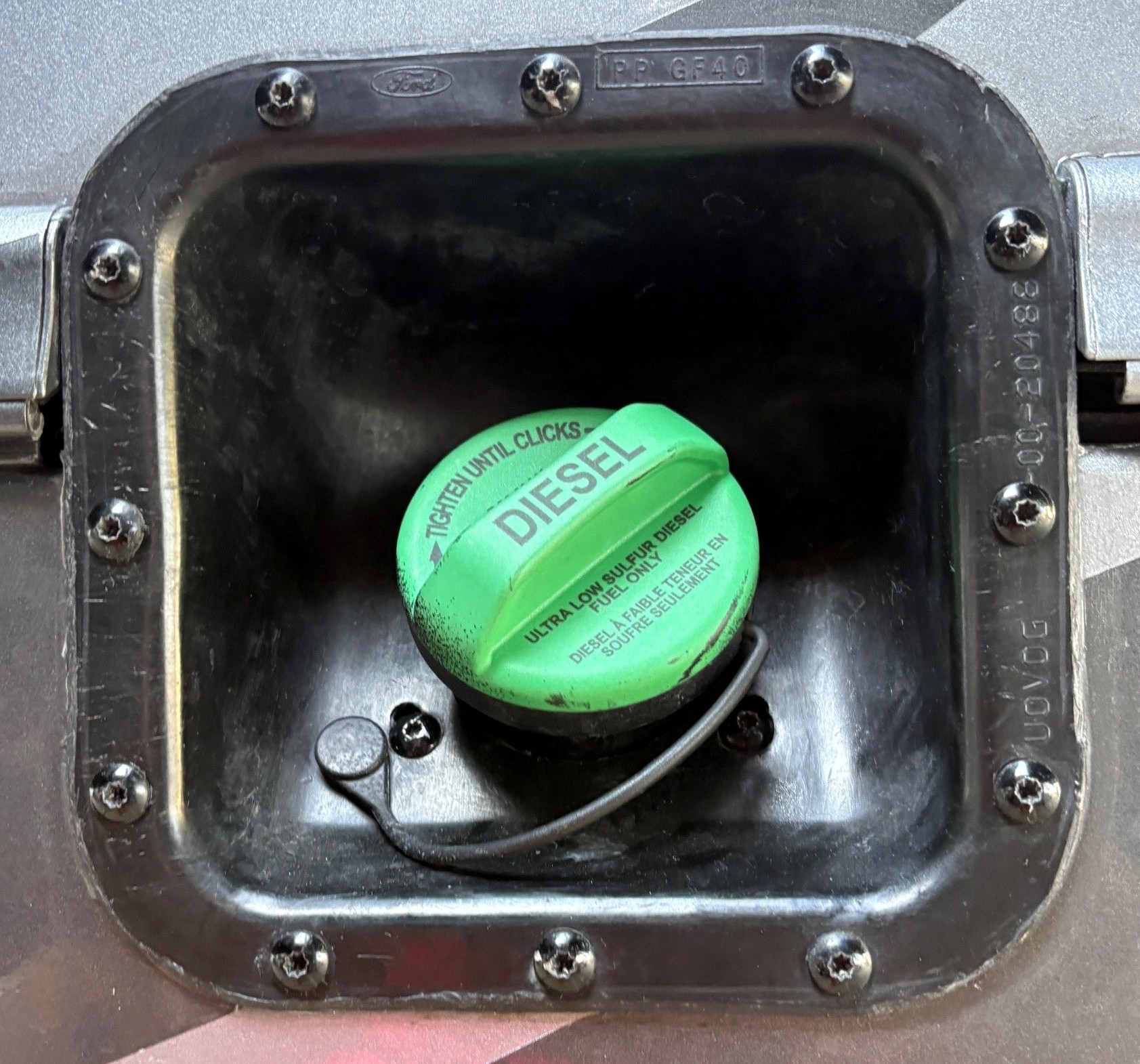 Unprotected factory fuel door on RV motorhome — vulnerable to fuel theft siphoning and contamination without a locking fuel door